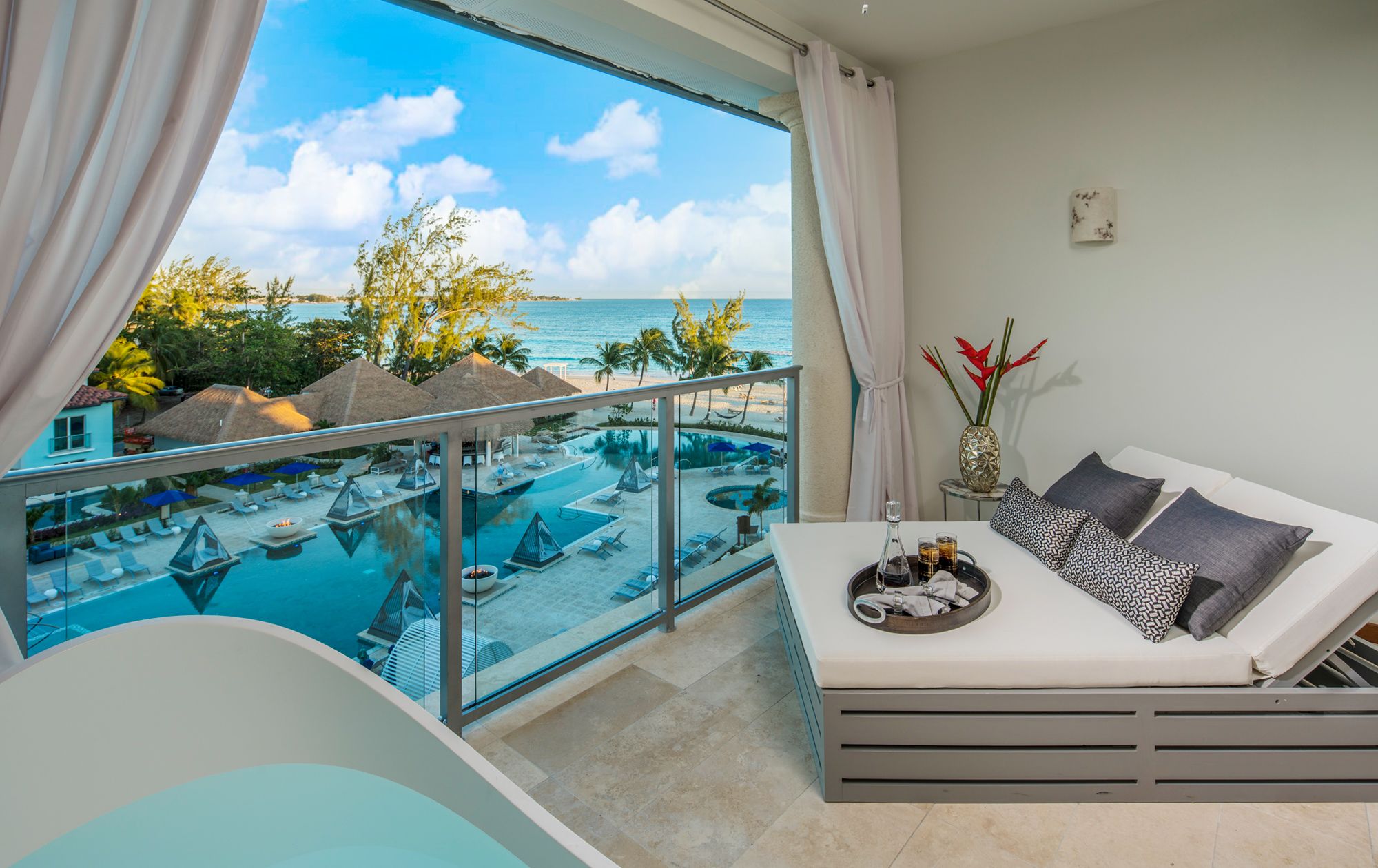 Ocean view hotel room with beach and water visible from the room
