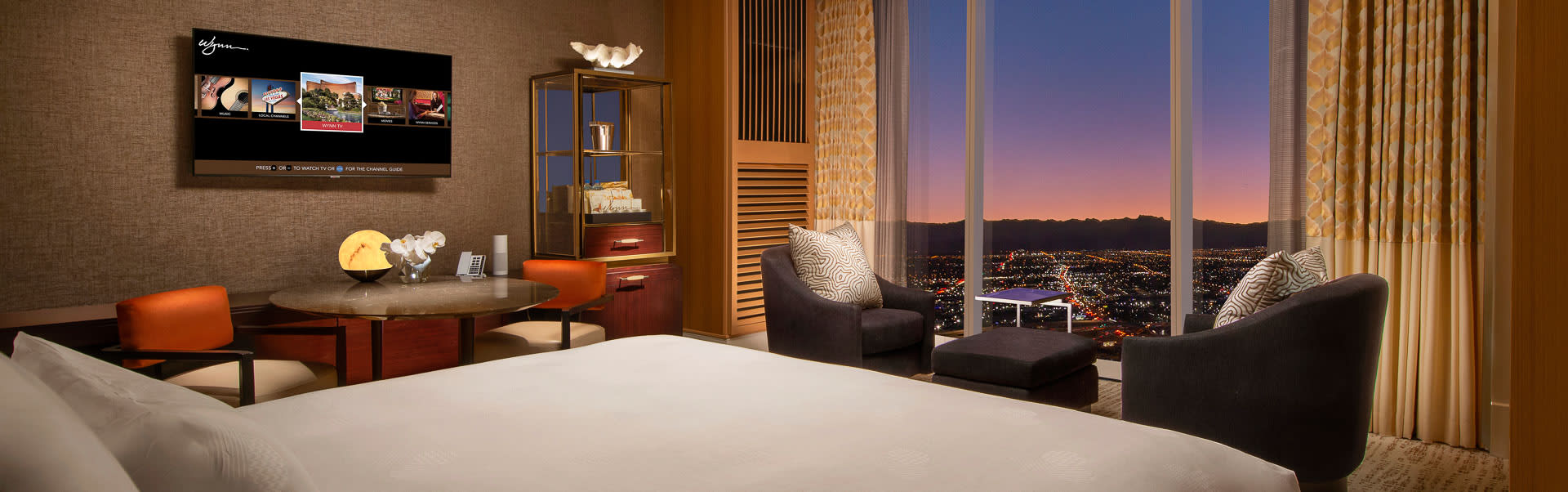 Corner panoramic hotel room with dual-window city skyline view